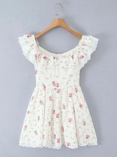 Cream off-shoulder floral mini dress with lace-trimmed ruffle neckline and lace hem, pink rose print, on wooden hanger.