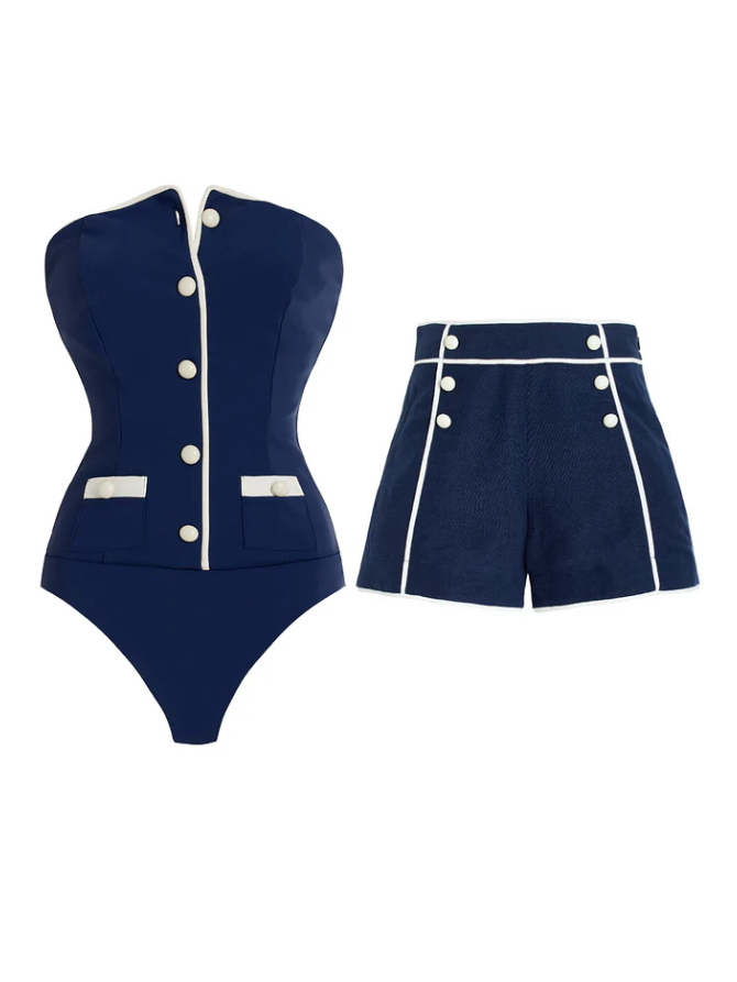 Navy blue strapless tube swimsuit with white piping and front buttons, plus matching navy shorts with white piping and buttons.