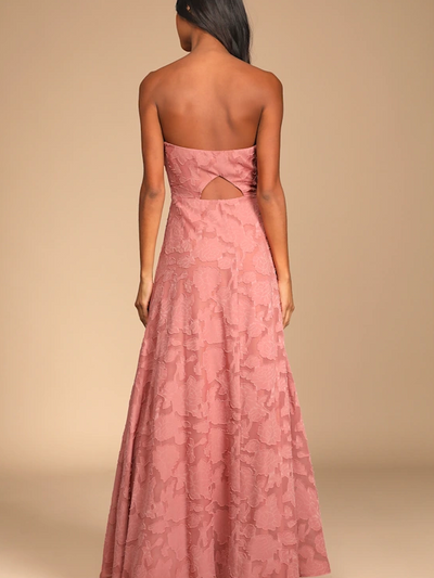 Back view of blush pink floral lace strapless sweetheart gown with a mid-back cutout and flowing floor-length skirt.