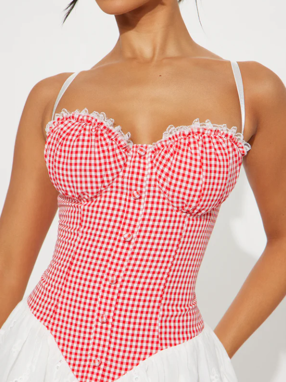 Red and white gingham bustier dress with lace-trimmed ruffles along the top, thin white straps, and a buttoned front.