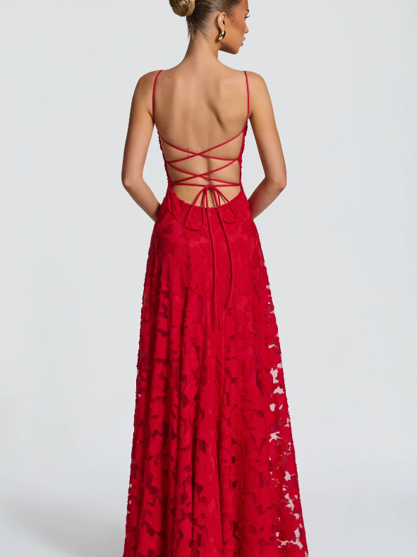 Back view of red floral lace maxi dress with thin spaghetti straps and crisscross lace-up back, floor-length A-line silhouette.