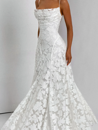 Ivory floral lace appliqué maxi dress with thin spaghetti straps, cowl neckline, fitted bodice, and A-line skirt.
