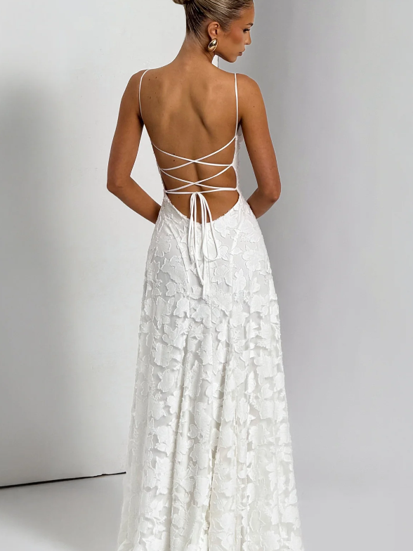 Back view of a white floral lace maxi dress with thin spaghetti straps and a lace-up crisscross back.