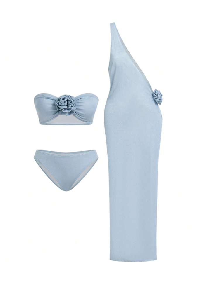 Ice blue three-piece swim set: bandeau top with flower, matching bottoms, and one-shoulder cover-up with side flower.