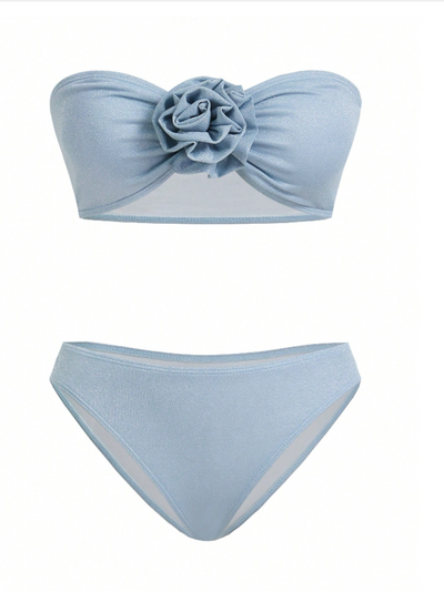 Ice blue bandeau bikini top with a gathered center rose; shimmering high-waisted bottoms with mesh side panels.