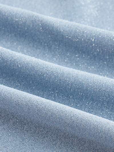 Close-up of ice-blue fabric with tiny sparkles and soft, wavy folds.