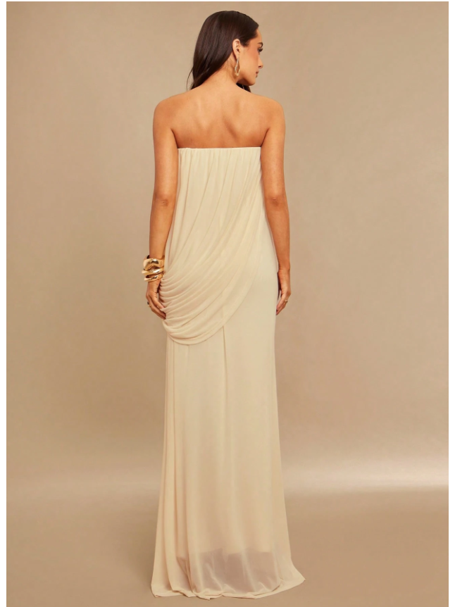 Back view of ivory strapless drape maxi dress with cascading drape detail at hip, floor-length chiffon.