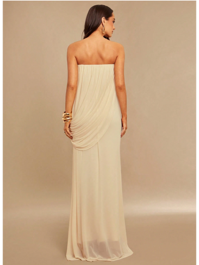 Back view of ivory strapless drape maxi dress with cascading drape detail at hip, floor-length chiffon.