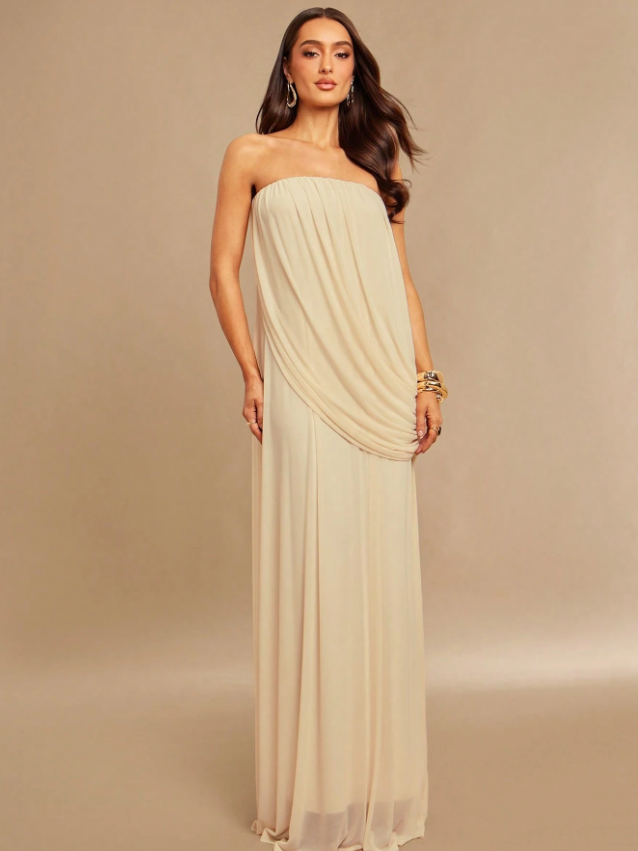 Ivory strapless draped maxi dress on a model, floor-length with soft flowing fabric and gathered front drape