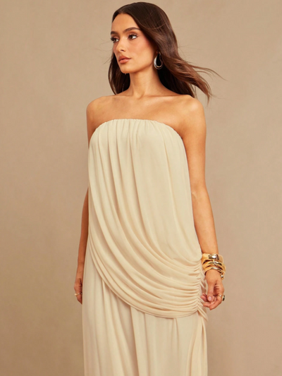 Ivory strapless draped maxi dress with ruched front in flowy chiffon, worn by model with gold bangles.