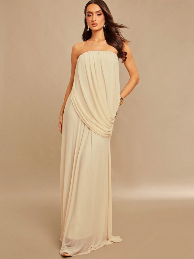 Ivory strapless draped maxi dress on a model with ruched bodice and cascading hip wrap, floor-length chiffon.