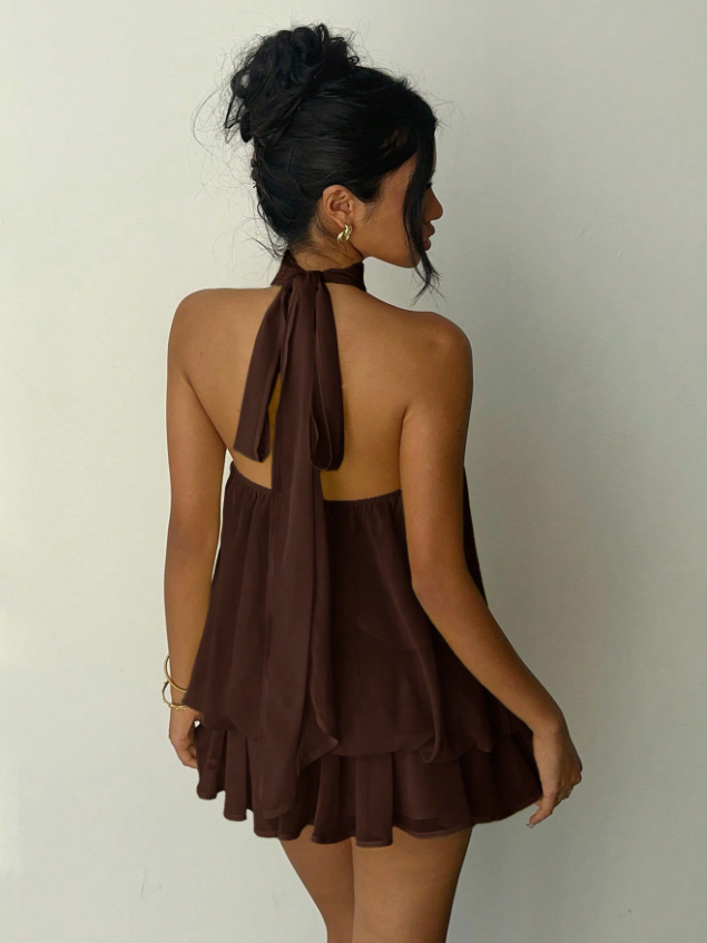 Chocolate brown halter-neck mini dress with tiered chiffon layers, backless with long neck tie, model with updo.