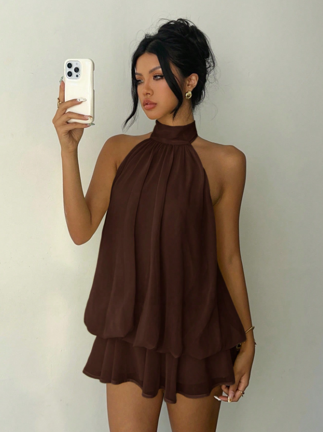 Chocolate brown halter-neck layered mini dress on a model taking a selfie with a phone.
