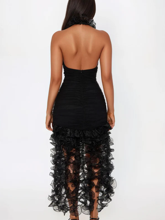 Back view of a black ruched halter mini dress with a choker-style neckline and layered sheer ruffle train.