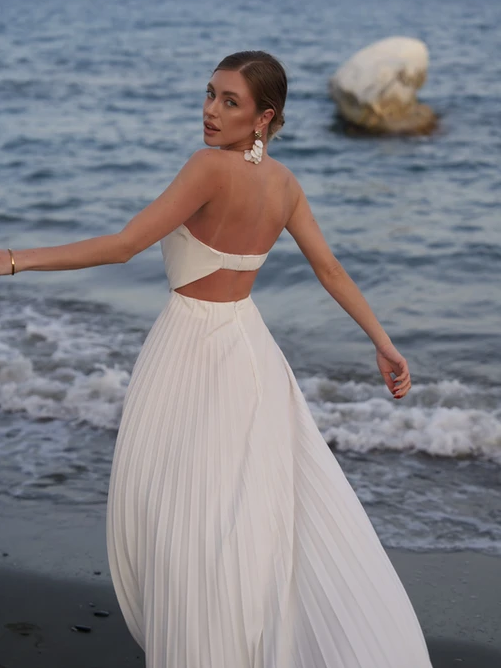 Gown by Exclusives: white strapless backless pleated maxi with high slit