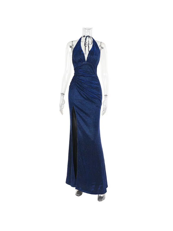 Navy blue shimmering backless halter maxi dress on a mannequin, plunging neckline, ruched waist, high slit.