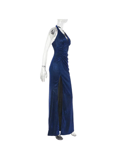 Blue shimmering backless halter-neck maxi dress with ruched bodice and a high slit on a clear mannequin.