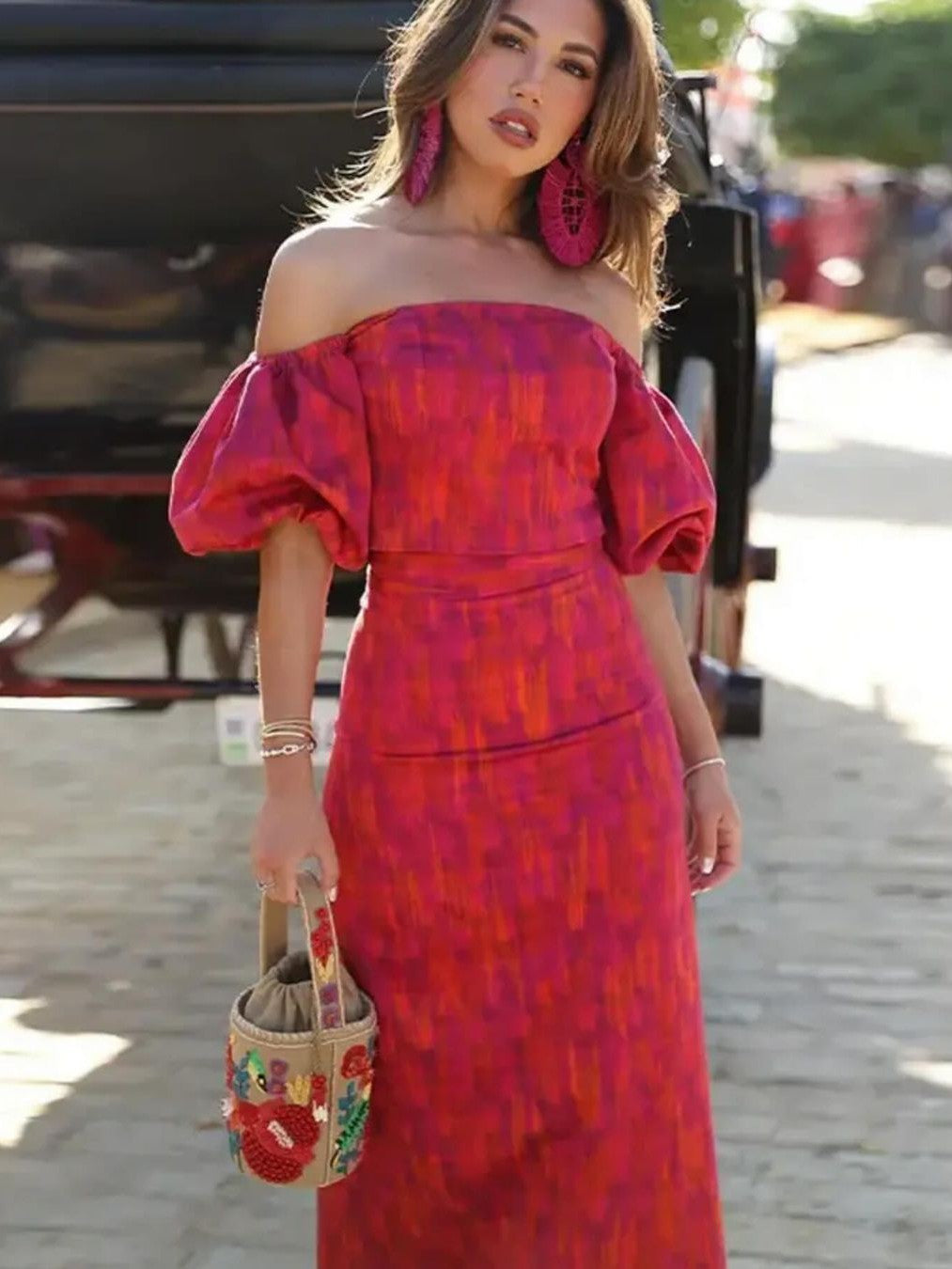 Model in a pink-purple printed off-shoulder puff-sleeve cami top with a matching high-waisted skirt; pink earrings.