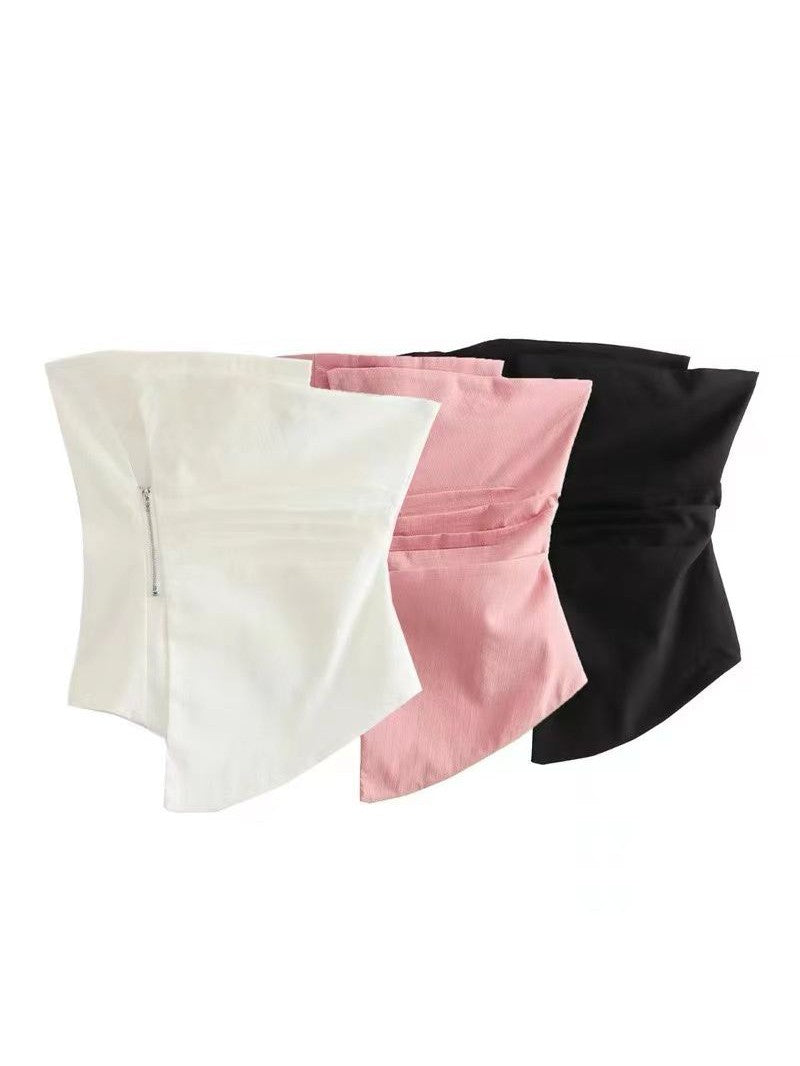 White asymmetric bandeau tube top with a left-side zipper, pink and black versions fanned behind.