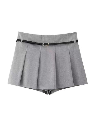 Grey pleated skort with slim black belt and silver buckle, front view with knife pleats.
