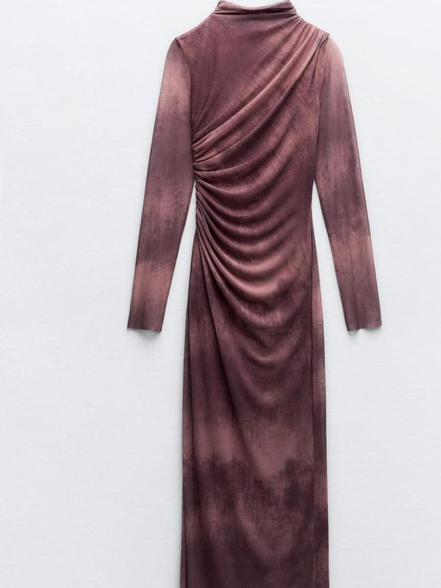 Back view of burgundy tie-dye mesh dress with a high neck, long sheer sleeves, and ruched draped side.