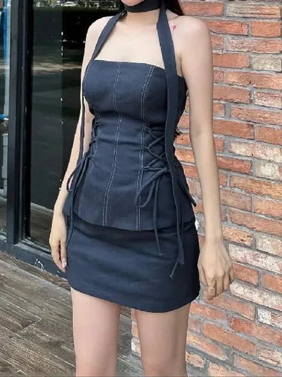 Navy blue strapless corset with vertical seams and side lacing, paired with a matching mini skirt.