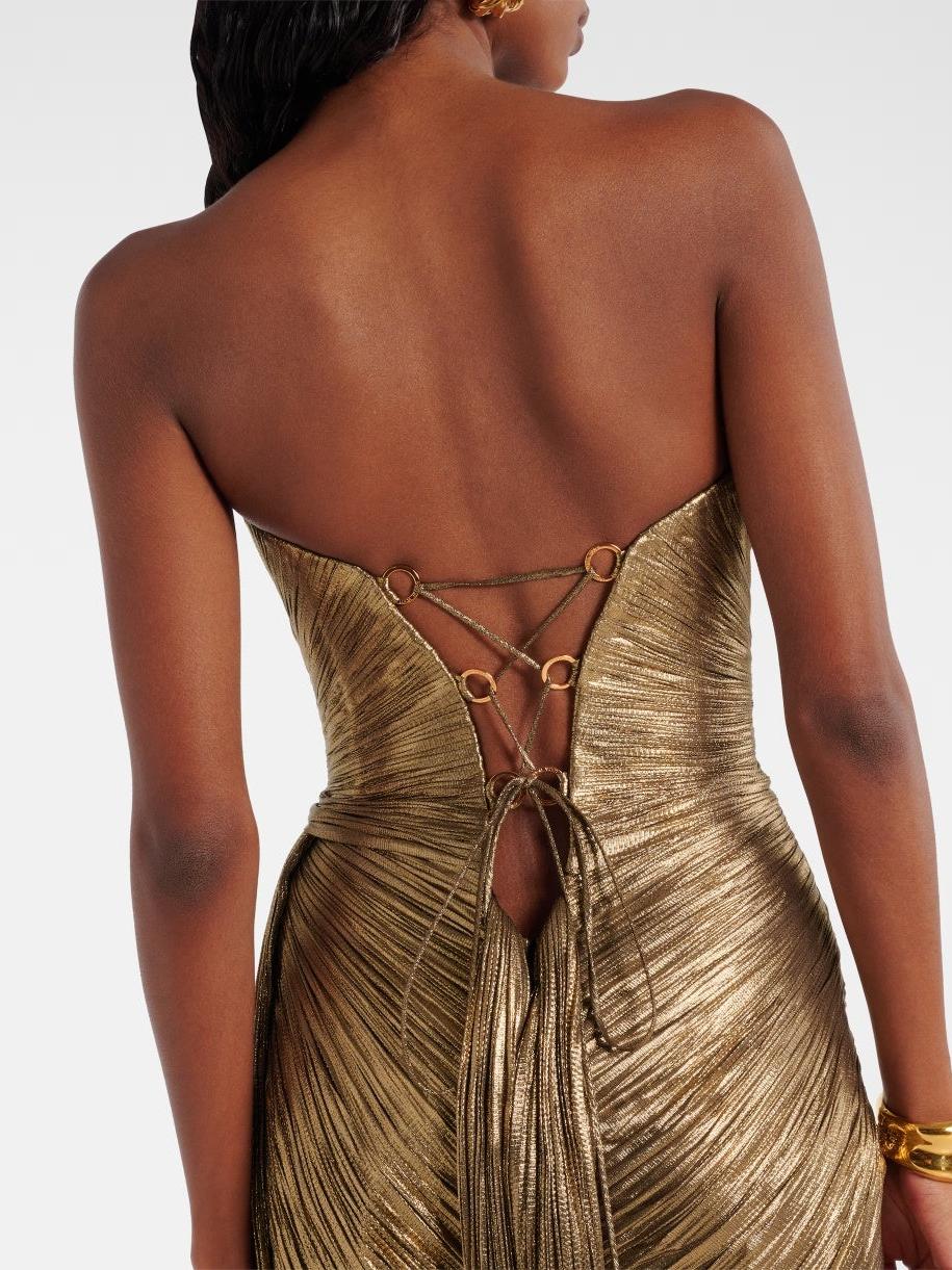 Back view of gold metallic pleated strapless maxi dress with ring-connected lace-up back and tassel ties.