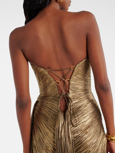 Back view of gold metallic pleated strapless maxi dress with ring-connected lace-up back and tassel ties.