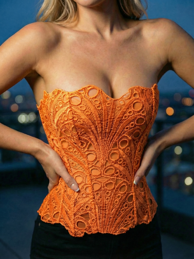Bright orange mesh lace tube top with scalloped edges, intricate circular patterns, strapless with tie-back detail.