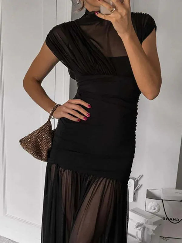 Black sheer mesh ruched pleated maxi dress with a high-neck bodice and a sheer, flowing floor-length skirt.