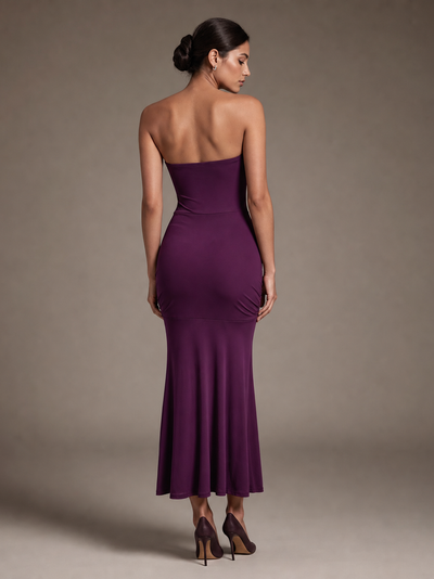 Sheath tube-top pleated purple evening dress by Exclusives; back view with a strapless, fitted bodice and flared hem.