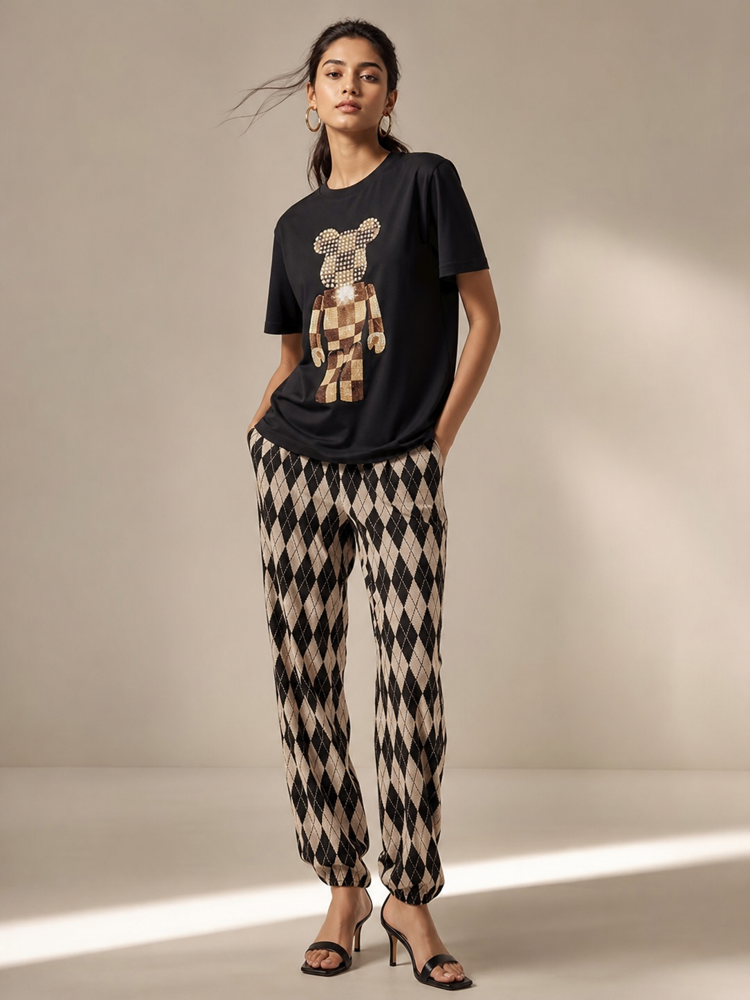 Print M O T-Shirt & Pants Coord Set with black tee featuring a sequined bear graphic and beige argyle pants