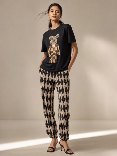Print M O T-Shirt & Pants Coord Set with black tee featuring a sequined bear graphic and beige argyle pants