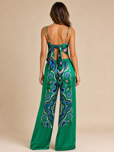 Strappy tube top and satin coord pants set by Exclusives in green with blue-pink abstract print.