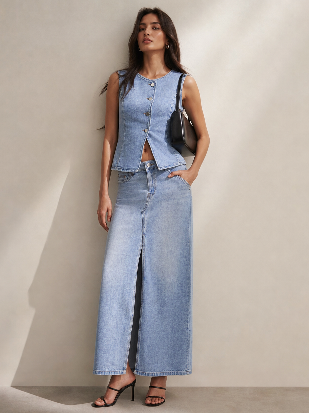 Mela Denim Vest Top & Slit Skirt Coord Set in light denim by Exclusives; sleeveless vest with front buttons and long slit skirt.