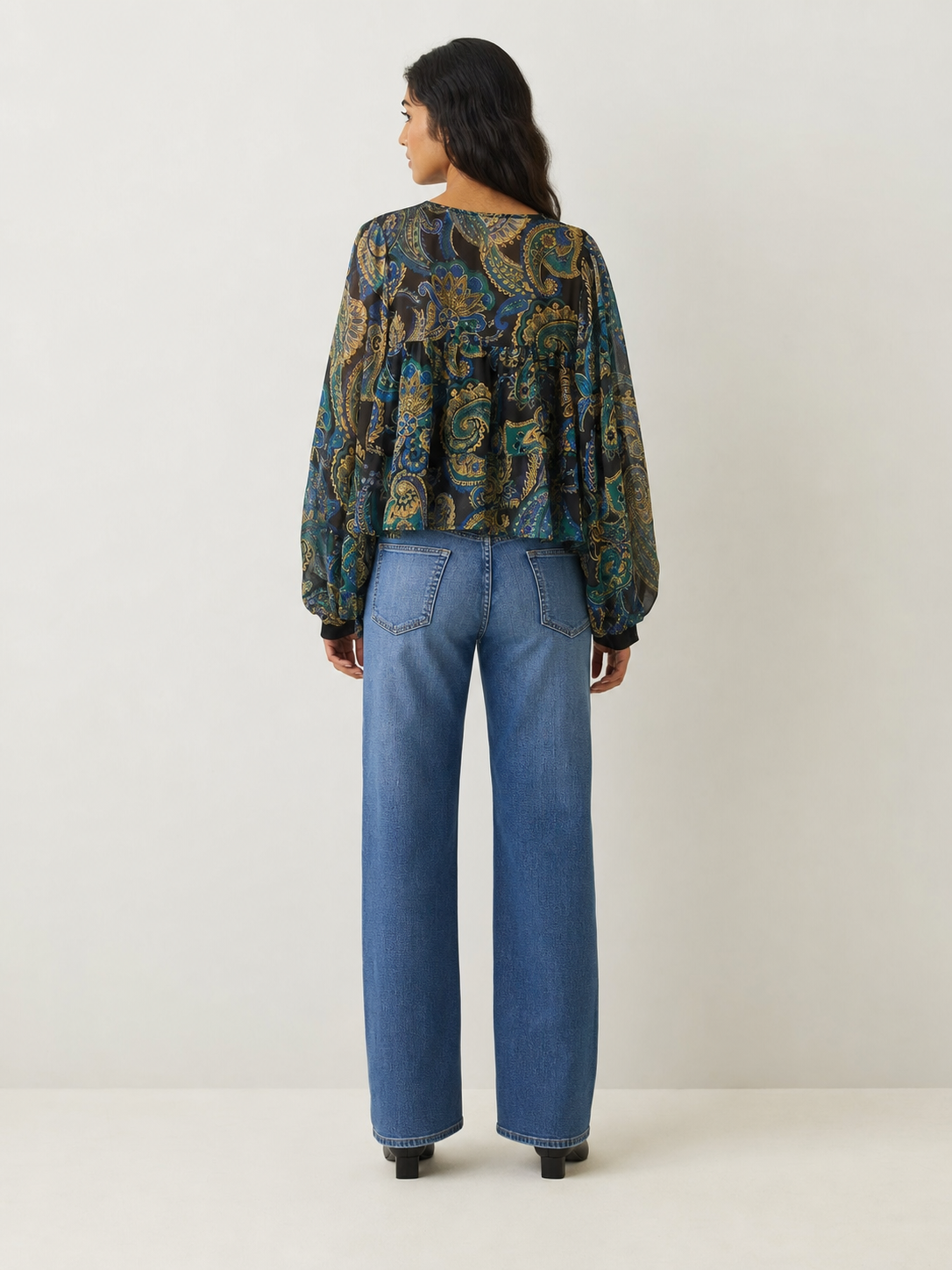 Floral Print Ruffle Blouse in sheer multicolor paisley on dark background with long puff sleeves