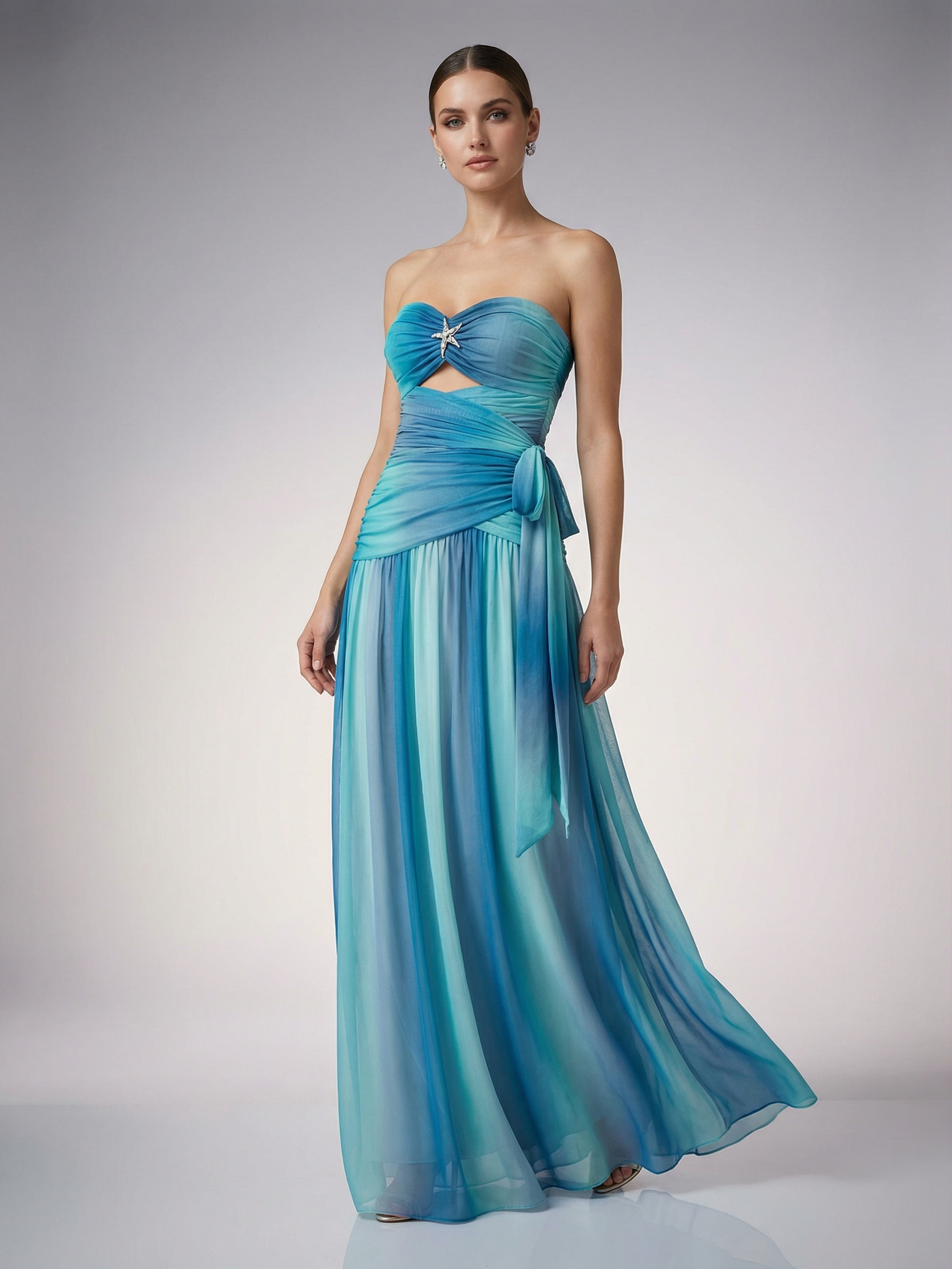 Strapless ombré ruched chiffon maxi dress in blue gradient, twisted bust with star brooch, midriff cutout, side tie.
