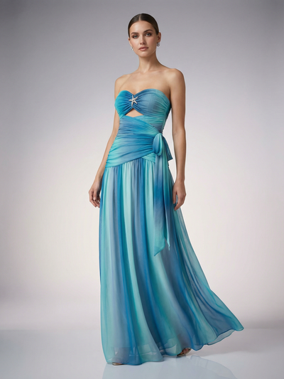 Strapless ombré ruched chiffon maxi dress in blue gradient, twisted bust with star brooch, midriff cutout, side tie.