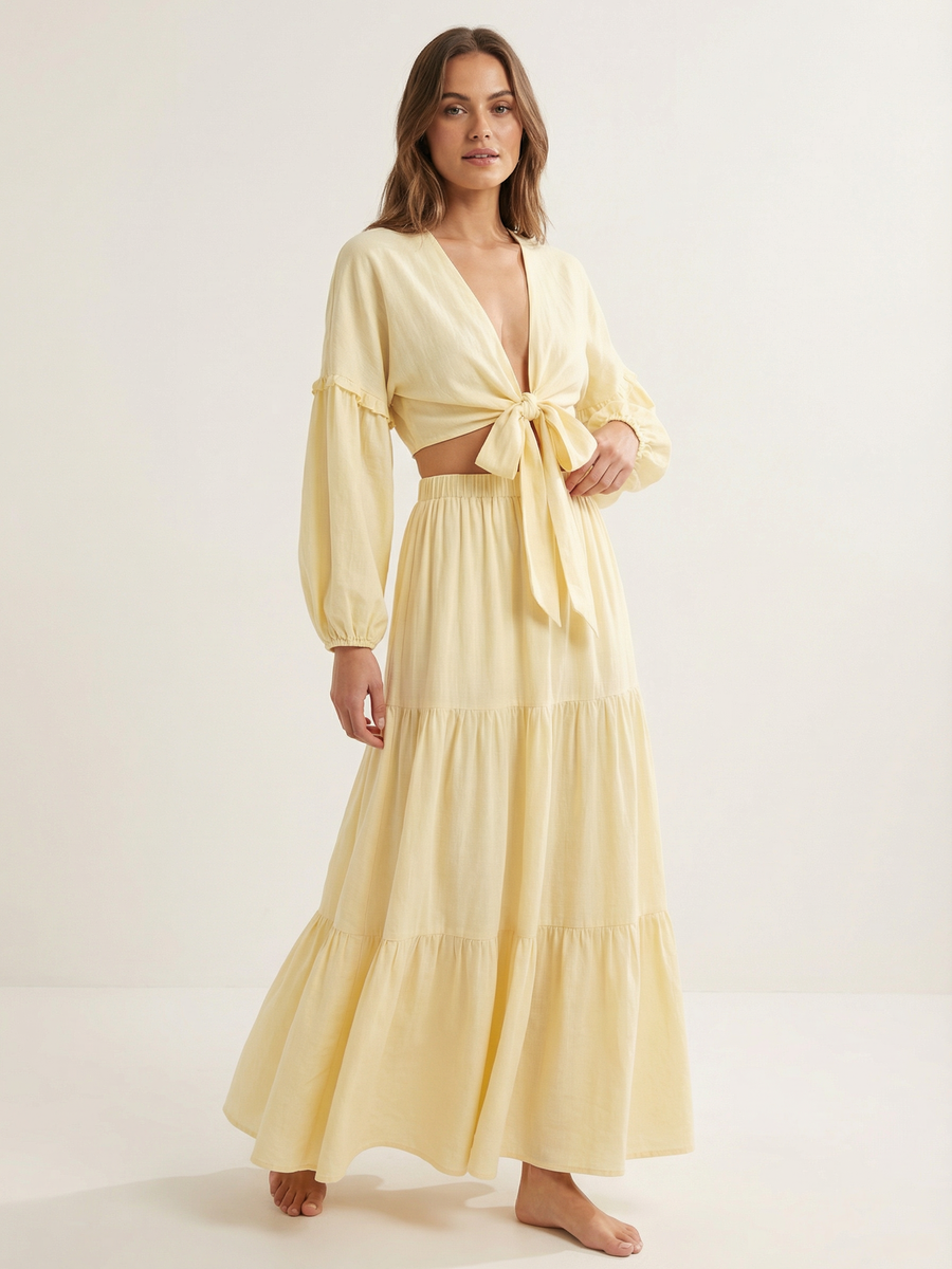 Soft yellow boho co-ord: tie-front crop top with long puff sleeves and deep V-neck, tiered maxi skirt