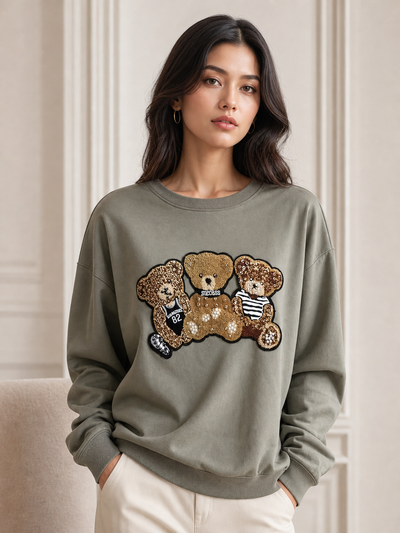 Panda Print Sweatshirt in olive green with gold sequin panda bear patch; relaxed fit for casual everyday wear.