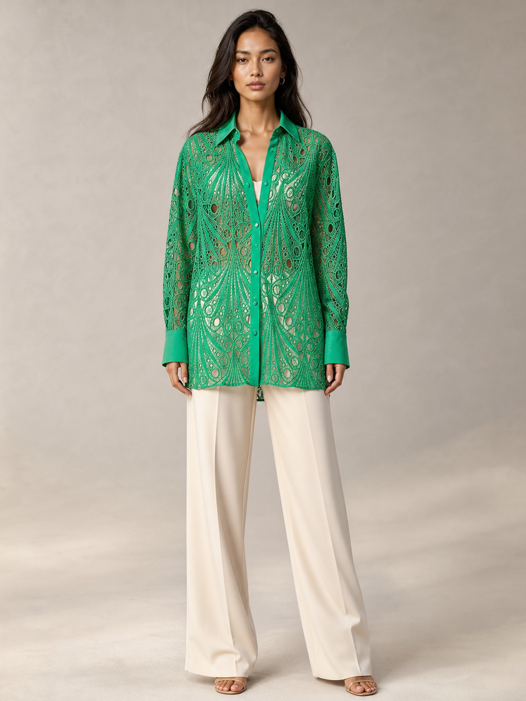 Crochet shirt by Exclusives; emerald green lace-knit top with long sleeves, over a white layer, beige wide-leg pants.