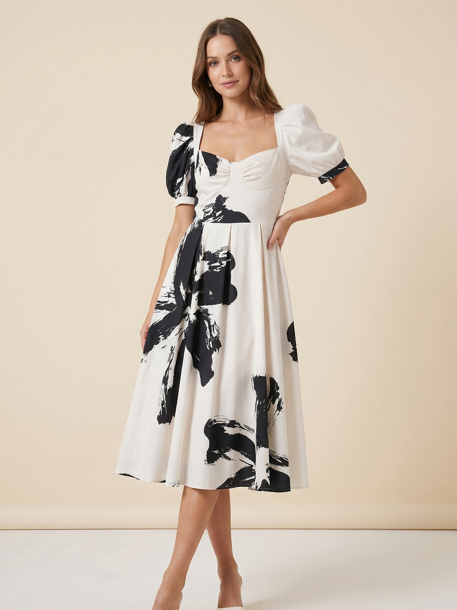 Cream midi dress with bold black brushstroke print, corset-style bodice and mismatched puff sleeves.