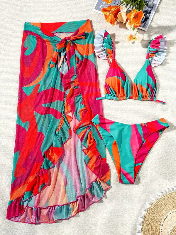 Bright abstract multicolor bikini set with a matching long wrap; turquoise, pink, orange, purple swirls, ruffles and bow.