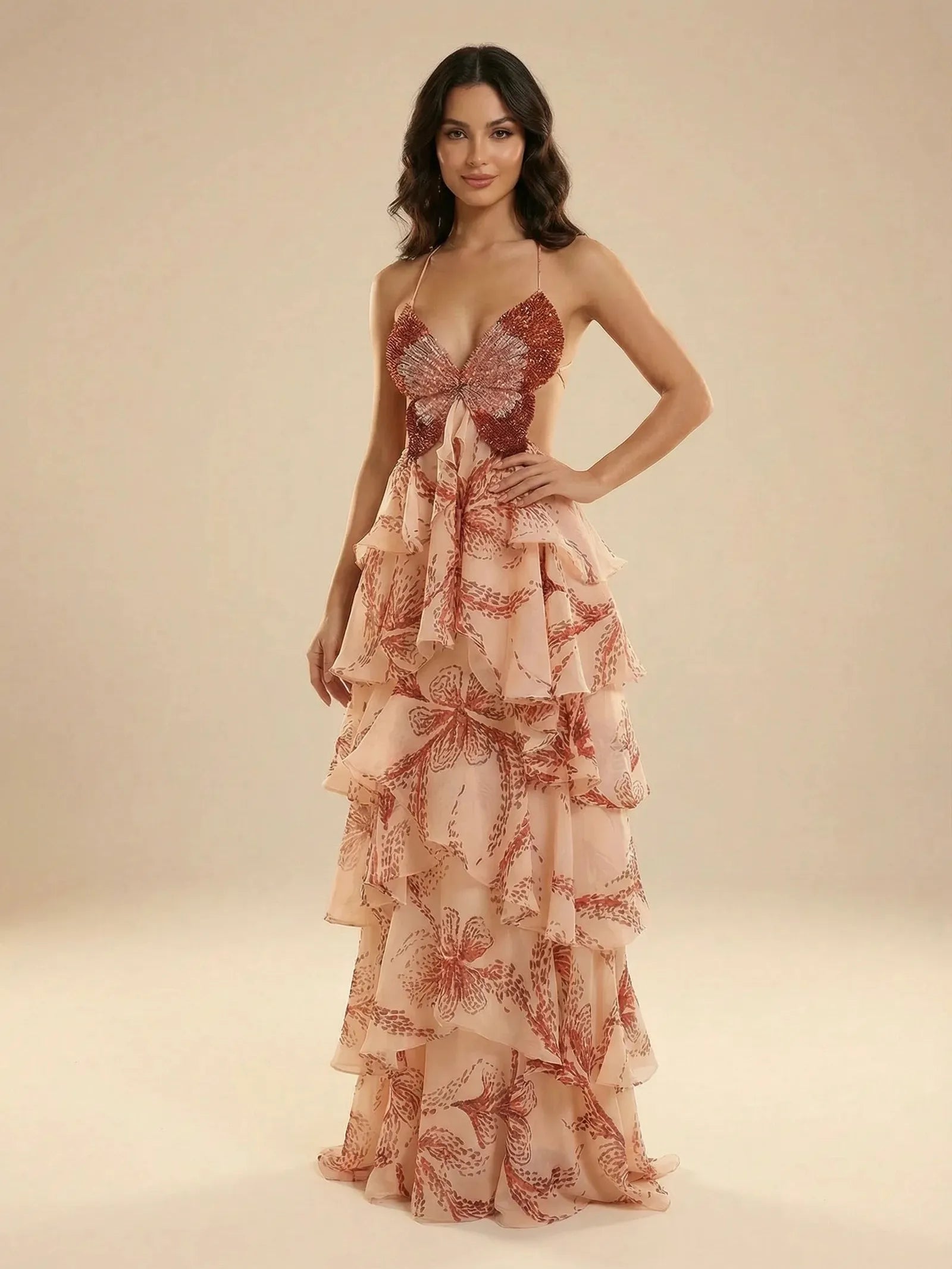 Blush pink butterfly-print tiered ruffle maxi dress with a red sequined butterfly bodice and thin spaghetti straps.