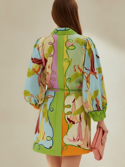 Tropical print balloon-sleeve shirt mini dress; vibrant greens, pinks and blues with leafy vines, back view.