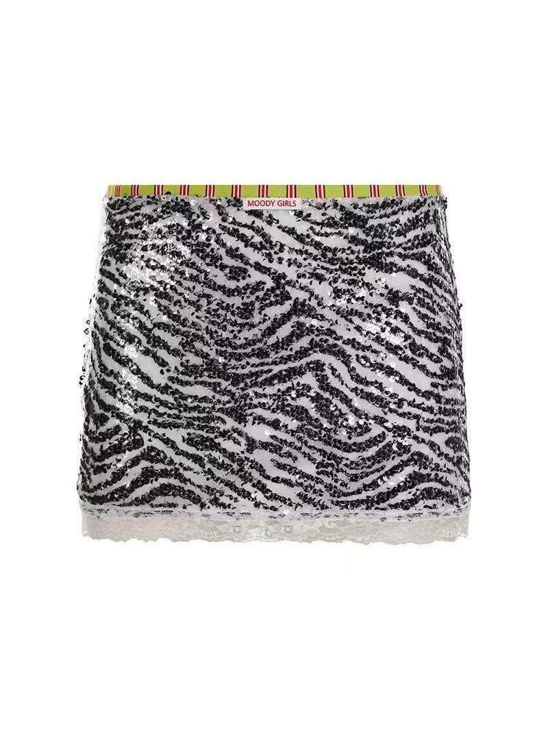 Zebra-print sequin mini skirt with lime-green striped waistband and white lace hem.