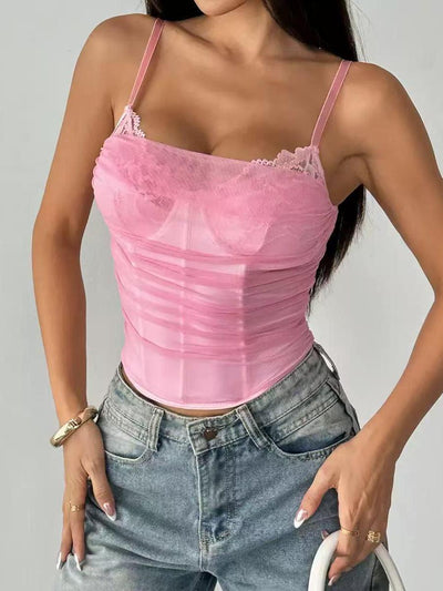 Pink ruched mesh corset cami top with lace trim, thin adjustable straps, paired with light-wash denim jeans.
