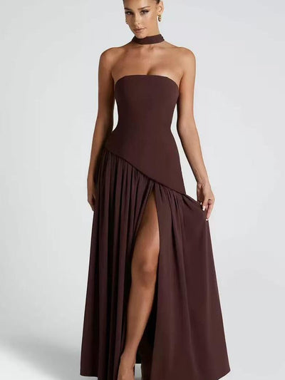 Deep burgundy strapless maxi dress with asymmetric draped panel and high slit, paired with a matching neck scarf.