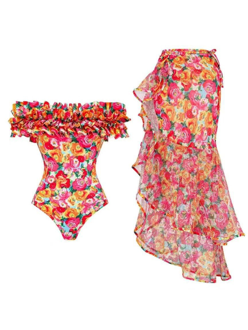 Bright floral print ruffle bodysuit with off-shoulder neckline and a sheer floral wrap skirt with ruffled edges.