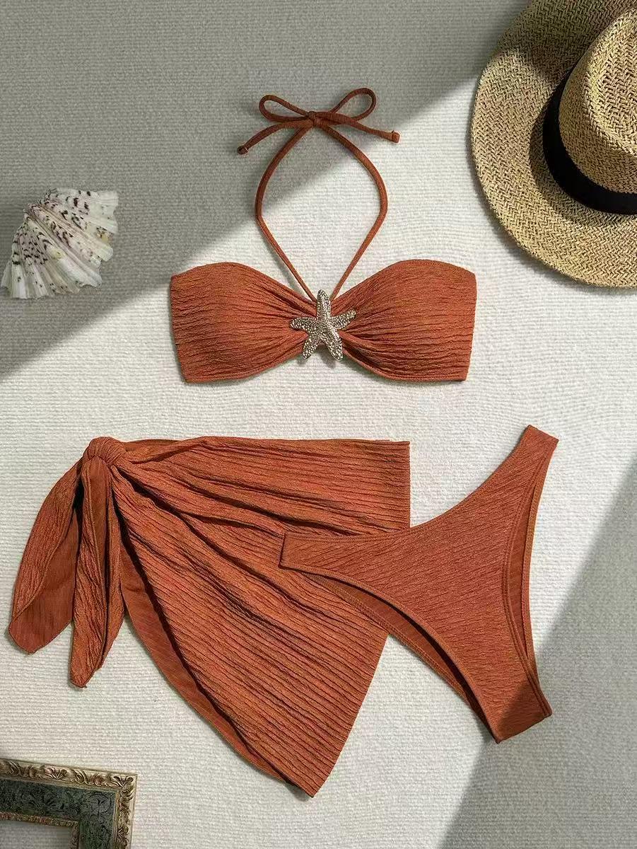 Starfish Glow textured bikini set in terracotta; bandeau top with halter straps and starfish detail, wrap-skirt bottom